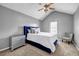 This bedroom features neutral gray walls, a ceiling fan and a statement blue bedframe at 5485 Shirewick Ln, Lithonia, GA 30058