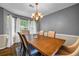 Elegant dining room featuring chandelier lighting, rug, and large windows at 5485 Shirewick Ln, Lithonia, GA 30058