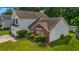 View of two-story house with a well-manicured lawn, flowerbeds, and two-car garage at 5485 Shirewick Ln, Lithonia, GA 30058
