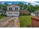 Charming two-story home with a well-manicured lawn, brick mailbox, and attached two car garage at 5485 Shirewick Ln, Lithonia, GA 30058