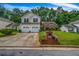 Charming two-story home with a well-manicured lawn, brick mailbox, and attached two car garage at 5485 Shirewick Ln, Lithonia, GA 30058