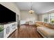 Inviting living room with hardwood floors, a comfy sectional, and large TV, perfect for entertaining at 5485 Shirewick Ln, Lithonia, GA 30058