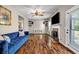 Bright living room featuring hardwood floors, a fireplace, and a door to the exterior at 5485 Shirewick Ln, Lithonia, GA 30058