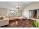 Bright living room boasting hardwood floors, large windows, and a cozy sectional, perfect for relaxation at 5485 Shirewick Ln, Lithonia, GA 30058