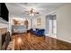 Bright living room featuring hardwood floors, a fireplace, and access to the kitchen at 5485 Shirewick Ln, Lithonia, GA 30058