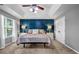 Spacious main bedroom with a tray ceiling, statement wall, plush carpet, and ample natural light at 5485 Shirewick Ln, Lithonia, GA 30058