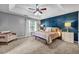 Inviting main bedroom featuring a statement wall, neutral decor, and lots of open space and natural light at 5485 Shirewick Ln, Lithonia, GA 30058