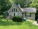 Charming home featuring large windows and covered with green trees at 590 Killian Road Rd, Canton, GA 30114