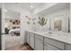 Bathroom featuring a double vanity, a large mirror, and stylish decorations, with a view into the bedroom at 221 Paisley Way, Locust Grove, GA 30248