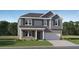 Charming two-story home with blue siding, gray brick, and a well-manicured front lawn at 221 Paisley Way, Locust Grove, GA 30248