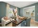 Stylish home office featuring a large desk, comfortable seating, and natural light at 221 Paisley Way, Locust Grove, GA 30248