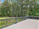 Gray back deck with wood railing offers scenic backyard views at 4720 Hull Rd, Conyers, GA 30094