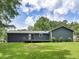 Backyard view of the home featuring a spacious deck, lush green grass, and privacy at 4720 Hull Rd, Conyers, GA 30094