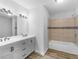 Stylish bathroom featuring a double sink vanity and a tiled shower-tub combo at 4720 Hull Rd, Conyers, GA 30094