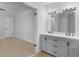 Bright bathroom featuring a gray double sink vanity and neutral paint at 4720 Hull Rd, Conyers, GA 30094