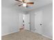 A gray bedroom with new carpet flooring, a ceiling fan, and a closet at 4720 Hull Rd, Conyers, GA 30094