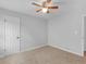 Neutral bedroom with plush carpet, ceiling fan, and light gray walls at 4720 Hull Rd, Conyers, GA 30094