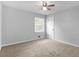 A gray bedroom featuring carpet flooring, a ceiling fan, and a window at 4720 Hull Rd, Conyers, GA 30094