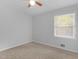A gray bedroom featuring carpet flooring, a ceiling fan, and a window at 4720 Hull Rd, Conyers, GA 30094