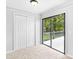 Bedroom featuring closet and glass sliding door with deck access at 4720 Hull Rd, Conyers, GA 30094