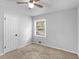 A gray bedroom featuring carpet flooring, a ceiling fan, and a window at 4720 Hull Rd, Conyers, GA 30094