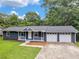 Charming single-story home with a welcoming front porch and a two-car garage, nestled in a lush, green landscape at 4720 Hull Rd, Conyers, GA 30094