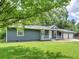 Well-maintained single-story home featuring a two-car garage, front porch and mature trees in a vibrant, green front yard at 4720 Hull Rd, Conyers, GA 30094