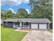 Charming single-story home with a welcoming front porch and a two-car garage, nestled in a lush, green landscape at 4720 Hull Rd, Conyers, GA 30094