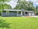 Inviting single-story home with a quaint front porch and two-car garage, surrounded by a well-kept lawn and mature trees at 4720 Hull Rd, Conyers, GA 30094
