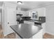 Modern kitchen with stainless steel appliances, white cabinets, and gray countertops at 4720 Hull Rd, Conyers, GA 30094