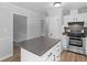 Bright kitchen showcasing stainless steel appliances, white cabinetry, and center island at 4720 Hull Rd, Conyers, GA 30094