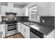 Stylish kitchen featuring stainless steel oven, gray countertops and white cabinetry at 4720 Hull Rd, Conyers, GA 30094