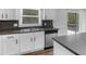 View of the kitchen featuring stainless steel dishwasher and sink, gray countertops and cabinets at 4720 Hull Rd, Conyers, GA 30094