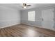 Bright living room with modern ceiling fan, beautiful wood floors, neutral paint and trim, and plenty of natural light at 4720 Hull Rd, Conyers, GA 30094