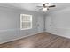 Bright living room with modern ceiling fan, beautiful wood floors, neutral paint and trim, and plenty of natural light at 4720 Hull Rd, Conyers, GA 30094