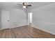 Spacious living room with wood floors, neutral paint and trim, base molding and modern ceiling fan at 4720 Hull Rd, Conyers, GA 30094