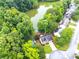 Aerial view of the property backing onto a tranquil lake surrounded by dense trees at 3229 Dunlin Lake Rd, Lawrenceville, GA 30044