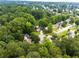 Wide aerial perspective showcasing a home nestled among lush greenery and mature trees in a serene neighborhood at 3229 Dunlin Lake Rd, Lawrenceville, GA 30044