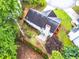 Aerial view of a private backyard, featuring a garden, concrete patio, and mature trees providing ample shade at 3229 Dunlin Lake Rd, Lawrenceville, GA 30044