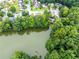 Aerial view of the home near a serene lake, surrounded by lush greenery at 3229 Dunlin Lake Rd, Lawrenceville, GA 30044