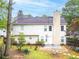 A shot of the back of the home, highlighting the yard, trees, and patio at 3229 Dunlin Lake Rd, Lawrenceville, GA 30044