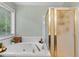 Bright bathroom with a large soaking tub and glass shower at 3229 Dunlin Lake Rd, Lawrenceville, GA 30044