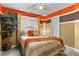 Inviting bedroom with striped bedding, decorative throw pillows, an accent wall, and an indoor tree at 3229 Dunlin Lake Rd, Lawrenceville, GA 30044