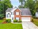 Charming two-story home featuring a well-manicured lawn, brick accents, and an attached two-car garage at 3229 Dunlin Lake Rd, Lawrenceville, GA 30044
