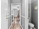 Hallway leading to a bathroom and bedroom with neutral paint, clean trim and modern floors at 3229 Dunlin Lake Rd, Lawrenceville, GA 30044