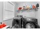 Modern laundry room featuring new washer and dryer units, complemented by ample shelving and storage at 3229 Dunlin Lake Rd, Lawrenceville, GA 30044