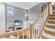 Open living room with fireplace, tall ceilings and views from the staircase landing at 3229 Dunlin Lake Rd, Lawrenceville, GA 30044