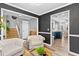 Cozy seating area with light gray walls and views of the kitchen and stairway at 3229 Dunlin Lake Rd, Lawrenceville, GA 30044