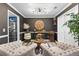 Stylish living room with dark walls, a unique clock, and comfortable seating at 3229 Dunlin Lake Rd, Lawrenceville, GA 30044