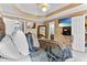 Spacious main bedroom with a tray ceiling, neutral walls, a television, and a view into the main bathroom at 3229 Dunlin Lake Rd, Lawrenceville, GA 30044